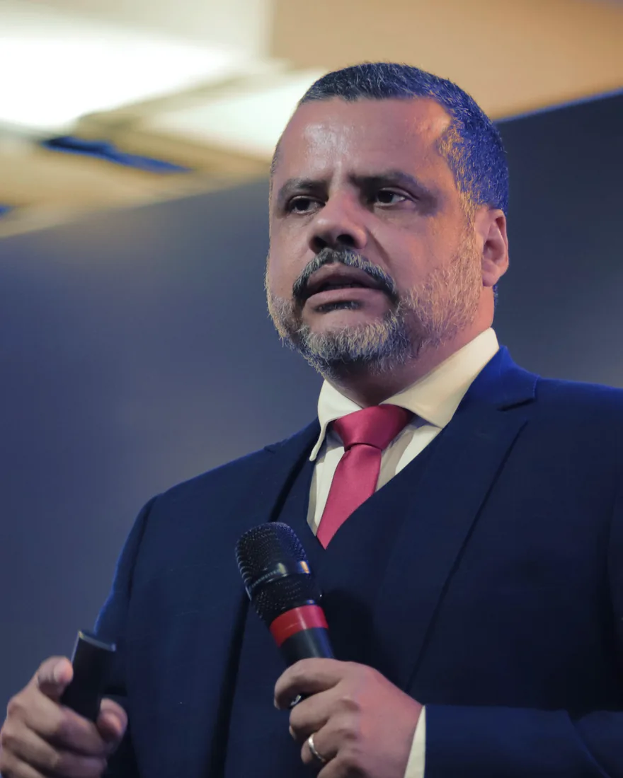 Cleidson Saldanha falando ao microfone num palco